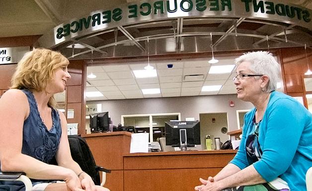 Advisor talking with a student at the Student Resource Center